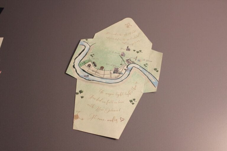 Cream envelope with a printed New Orleans river map liner and a matching personalized card