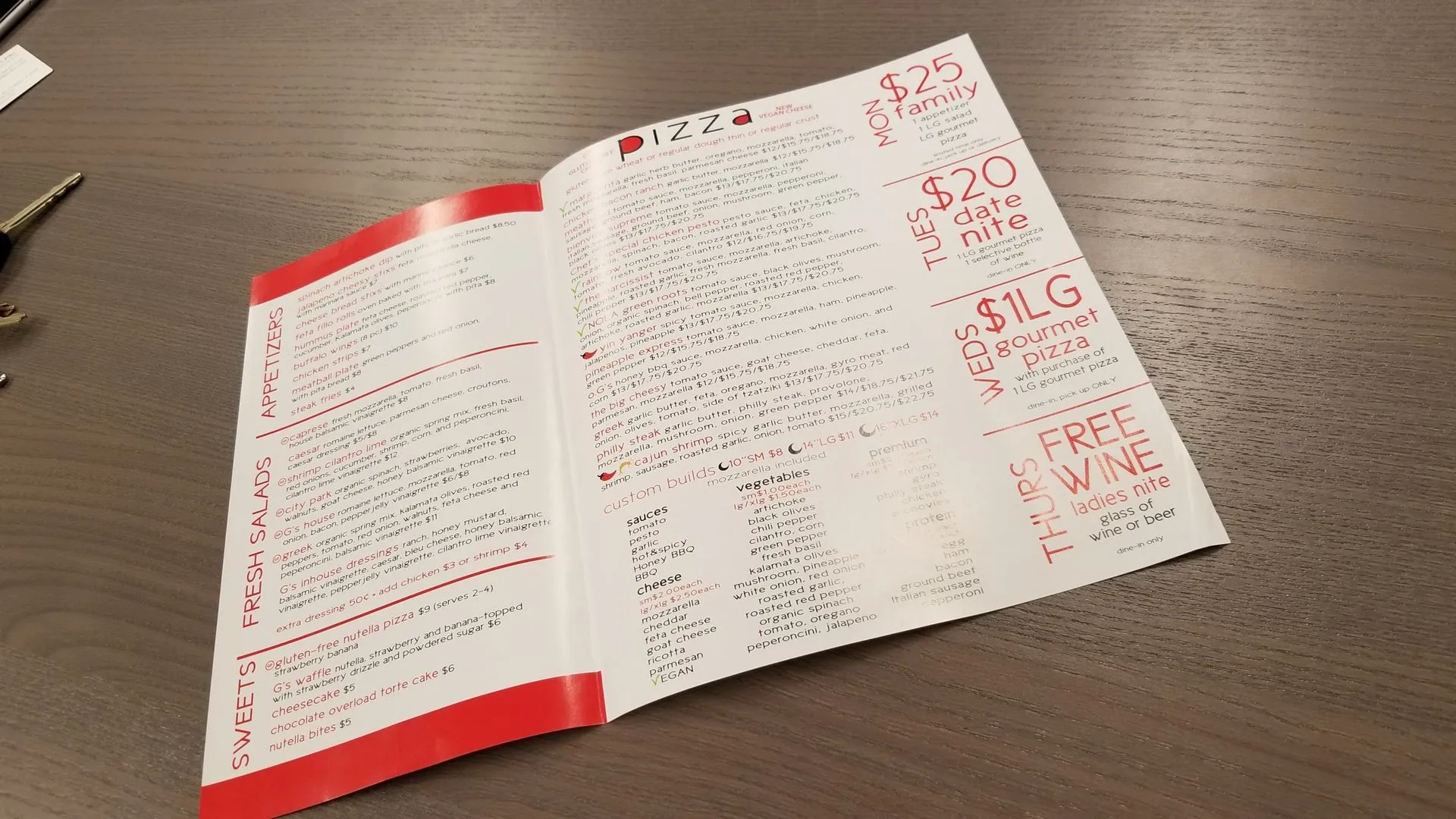 Printed restaurant menu with a red spine, open on a table